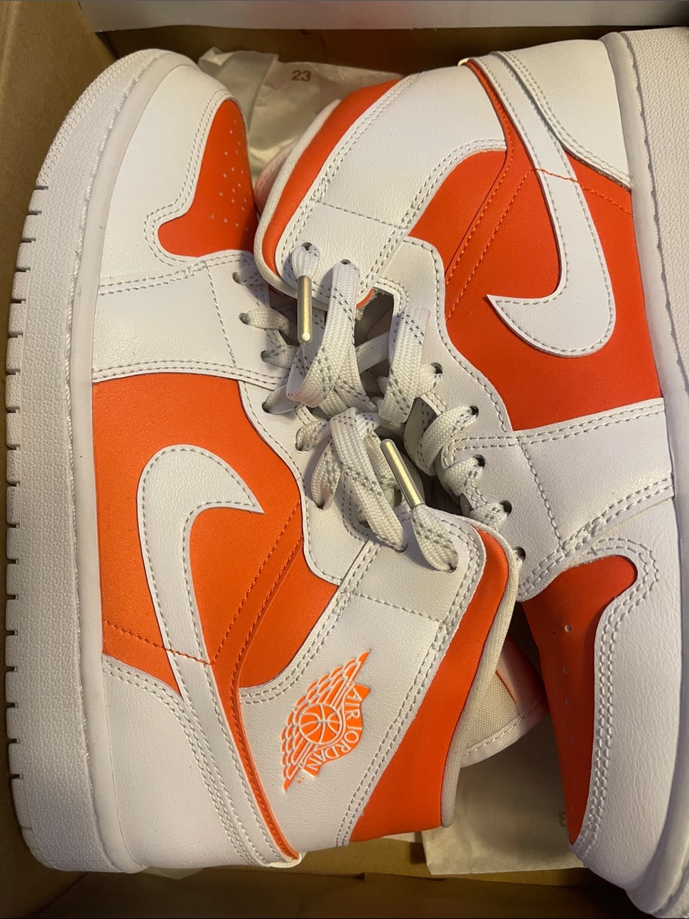 Nike Women’s Air Jordan 1 Mid White and Orange Sneakers